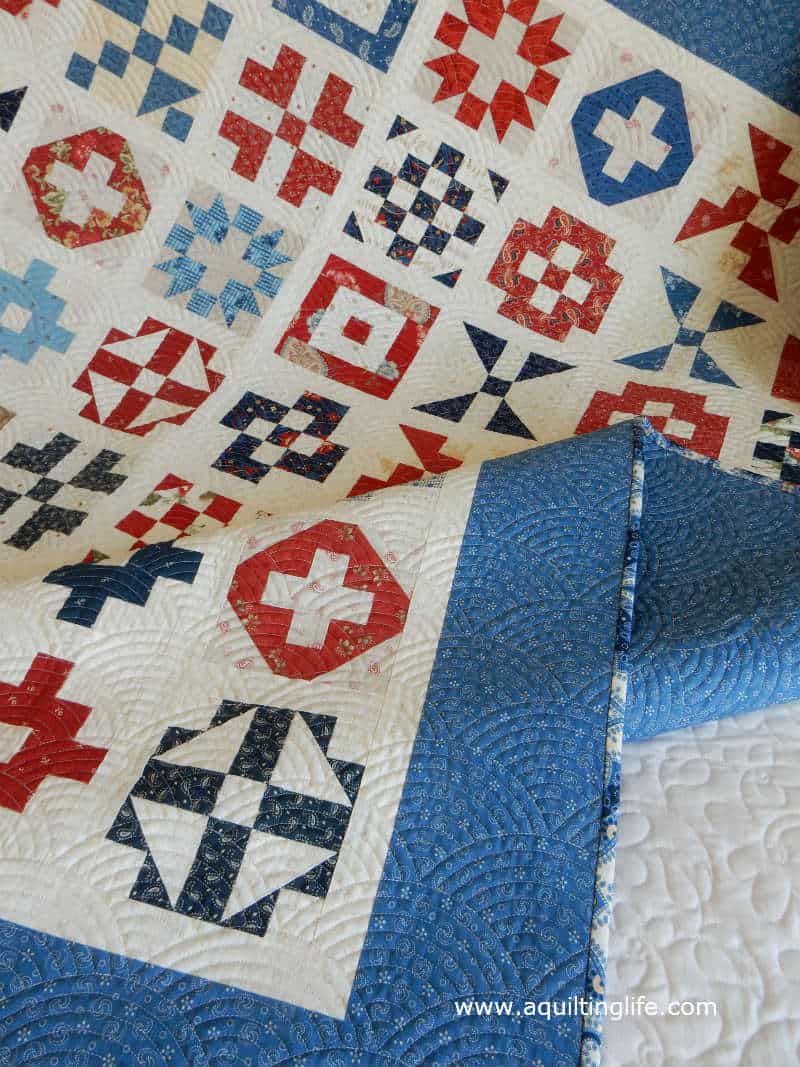 Red, cream, and blue sampler quilt