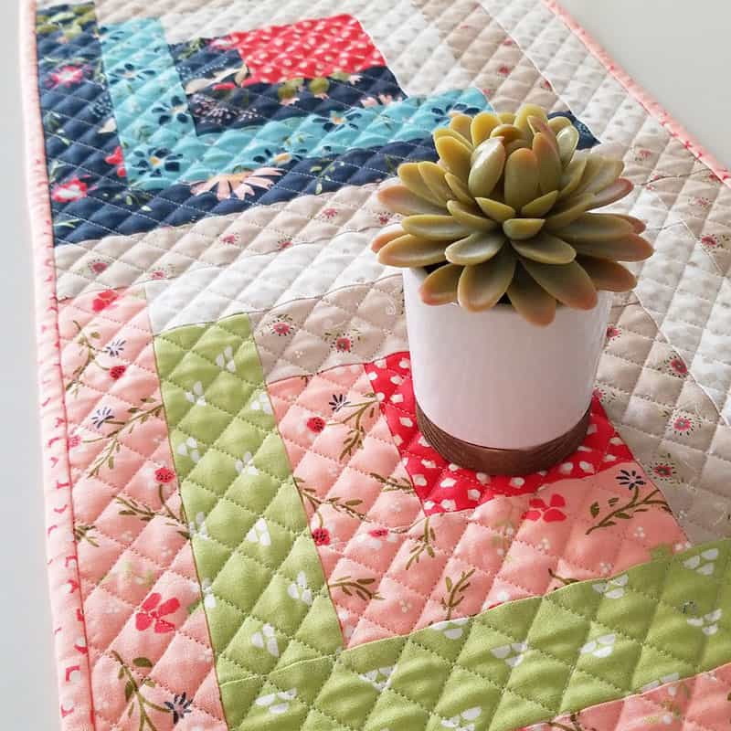 Saturday Seven Inspiration for Quilters 75 featured by top SU quilting blog, A Quilting Life: image of Walkabout Log Cabin Runner