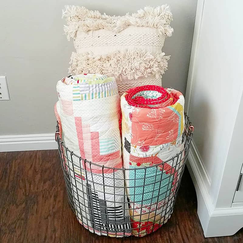 quilts in decorative wire basket
