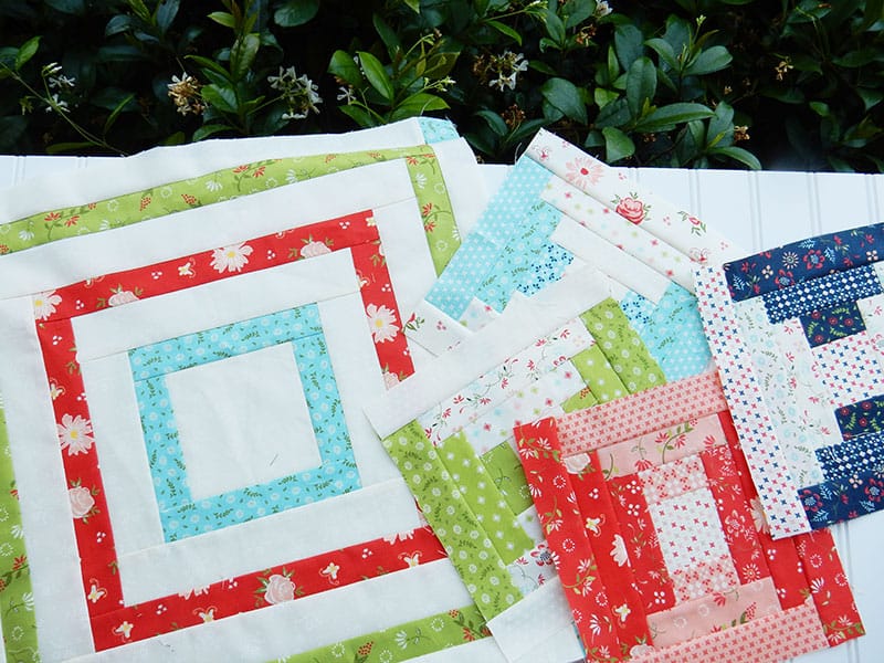 Courthouse Steps quilt blocks | Courthouse Steps Quilt Block Tutorial by popular quilting blog, A Quilting Life: image of 5 variating sized Courthouse steps quilt blocks.