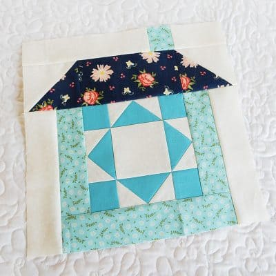 Merry Mini Christmas Sew Along Block 3 by popular quilting blog, A Quilting Life: image of a house block quilt.