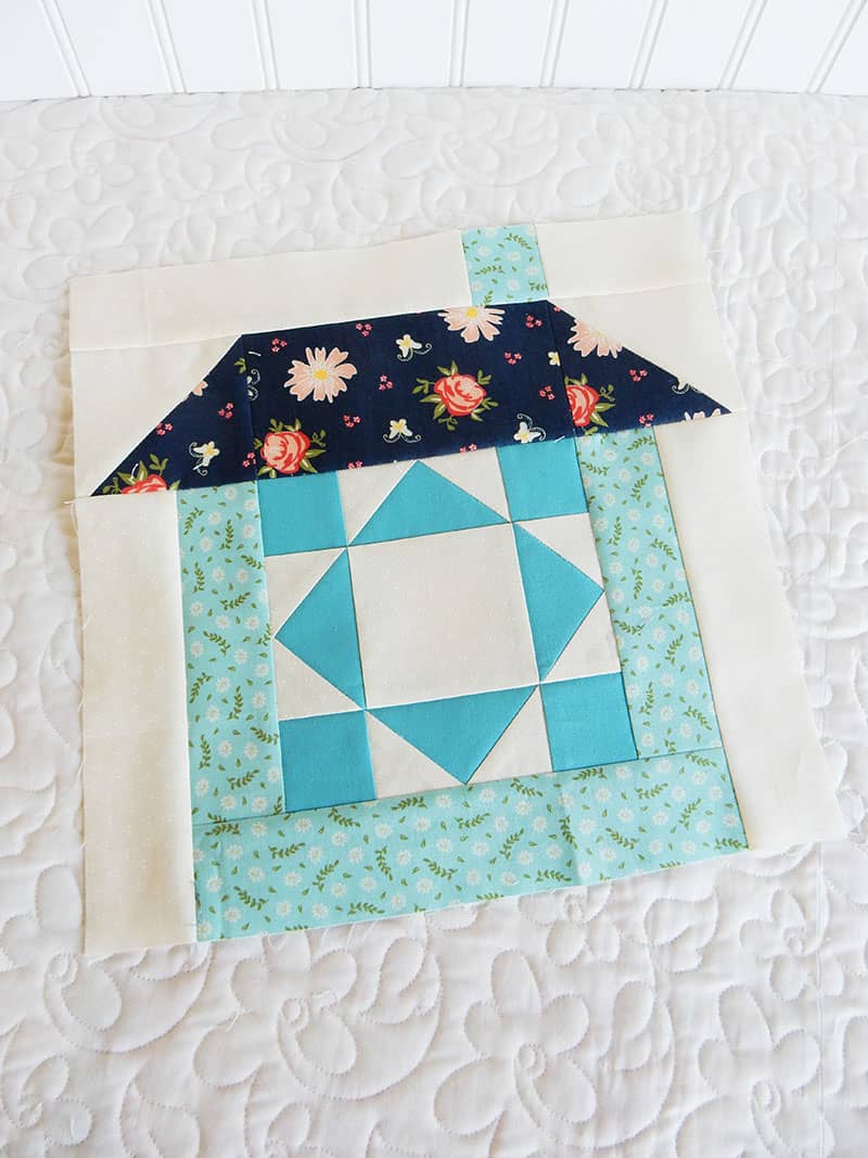 Merry Mini Christmas Sew Along Block 3 by popular quilting blog, A Quilting Life: image of blue and white house block mini quilt.