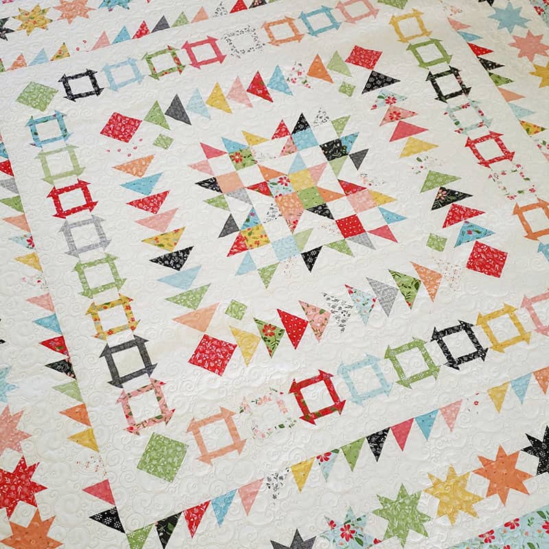 Gelato Medallion Quilt Pattern by popular US quilting blog, A Quilting Life: image of a Gelato Medallion quilt with scrappy star center.