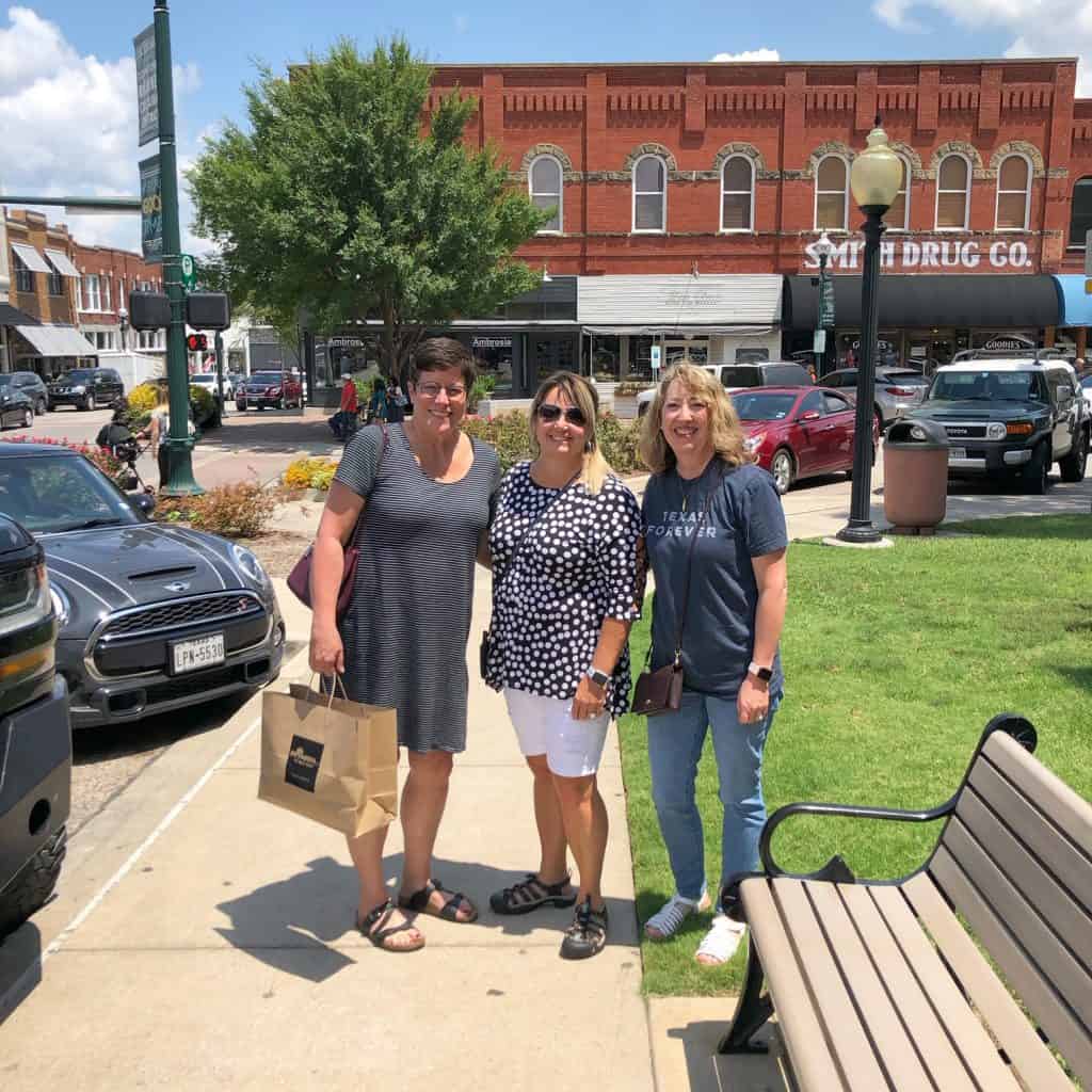 Quiltstock & Restore Quilt Retreats by popular quilting blog, A Quilting Life: image of three women standing outside of Primitive Gatherings.