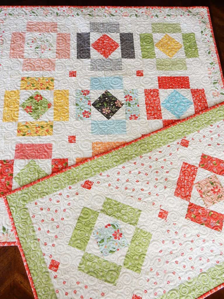Charm pack table runner & topper | Simply Charming Charm Pack Runner & Table Topper Quilt Pattern by popular US quilting blog, A Quilting Life: image of a finished Simply Charming table runner and topper.