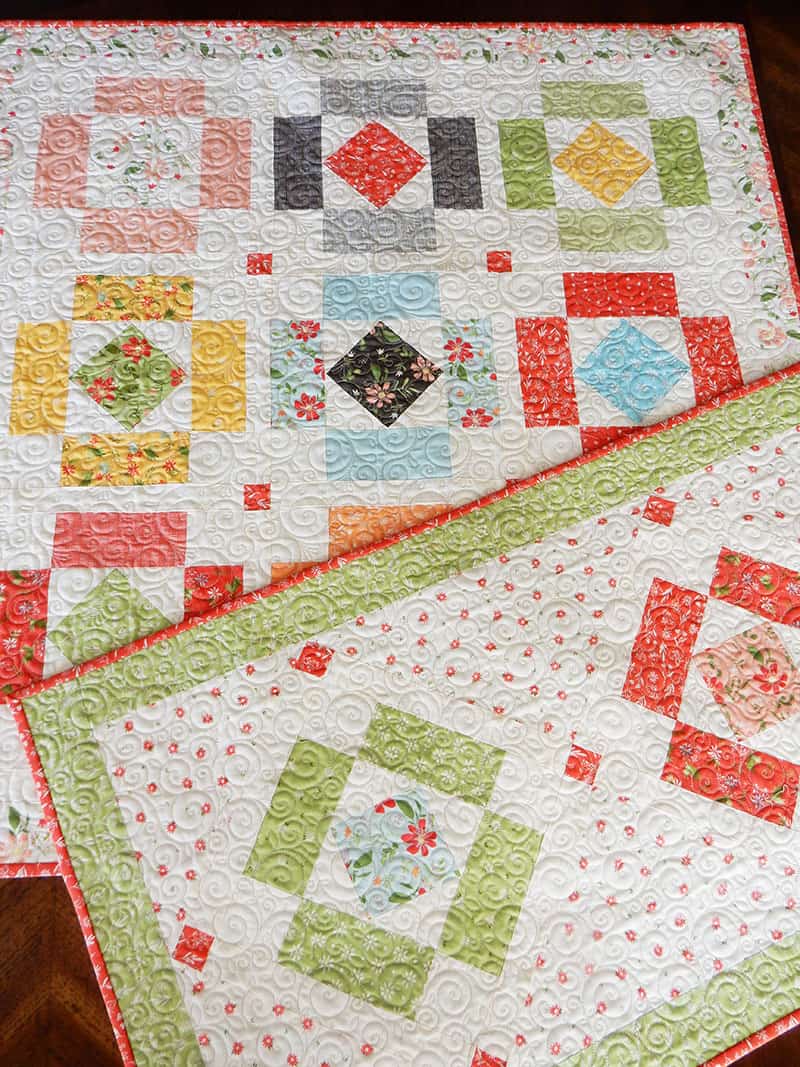 Charm pack table runner & topper | Simply Charming Charm Pack Runner & Table Topper Quilt Pattern by popular US quilting blog, A Quilting Life: image of a finished Simply Charming table runner and topper.