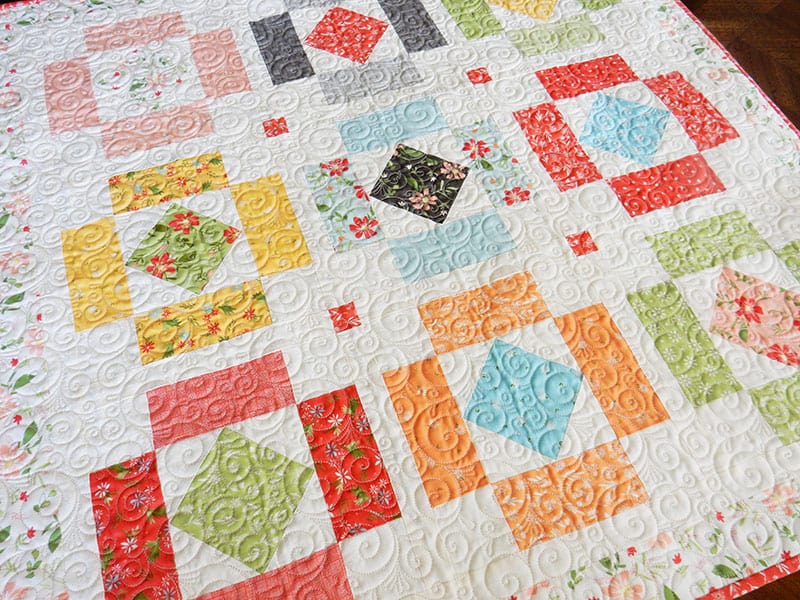 Simply Charming Table topper | Simply Charming Charm Pack Runner & Table Topper Quilt Pattern by popular US quilting blog, A Quilting Life: image of a finished Simply Charming table topper.