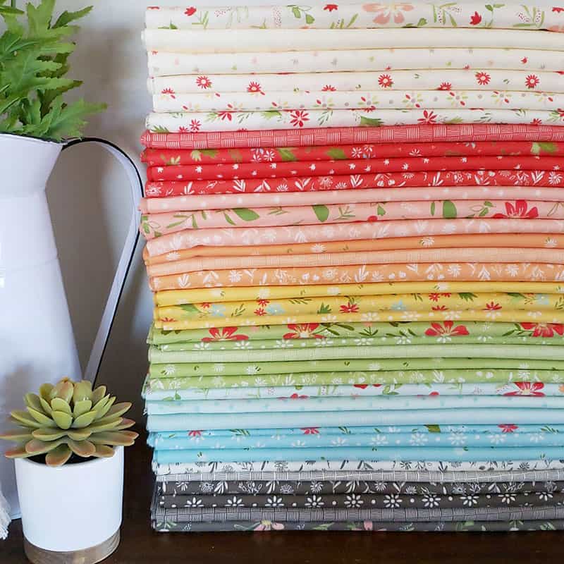 Introducing Summer Sweet Fabric by Sherri & Chelsi by popular US quilting blog, A Quilting Life: image of a stack of Summer Sweet fabric.