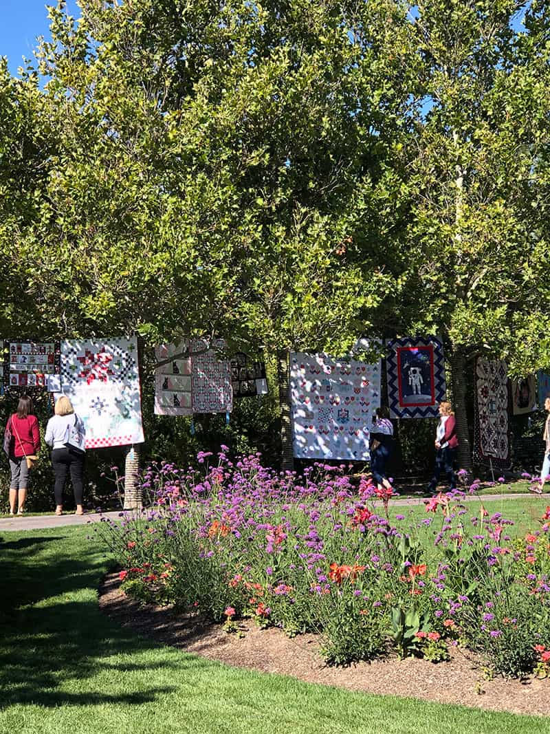Ashton Gardens Quilts | Harper's Garden Shop Update & Life Lately by popular US quilting blog, A Quilting Life: image of various quilts displayed in the Ashton Gardens at Thanksgiving Point.