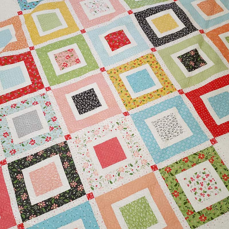 Beach Day Jelly Roll + charm pack quilt | National Sew a Jelly Roll Day by popular quilting blog, A Quilting Life: image of Beach Day Jelly Roll and charm pack quilt.