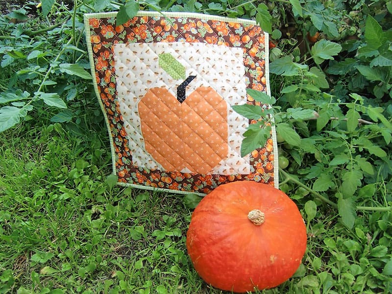 Pumpkin mini quilt | Small Fall Quilt Projects by popular quilting blog, A Quilting Life: image of a pumpkin mini quilt.
