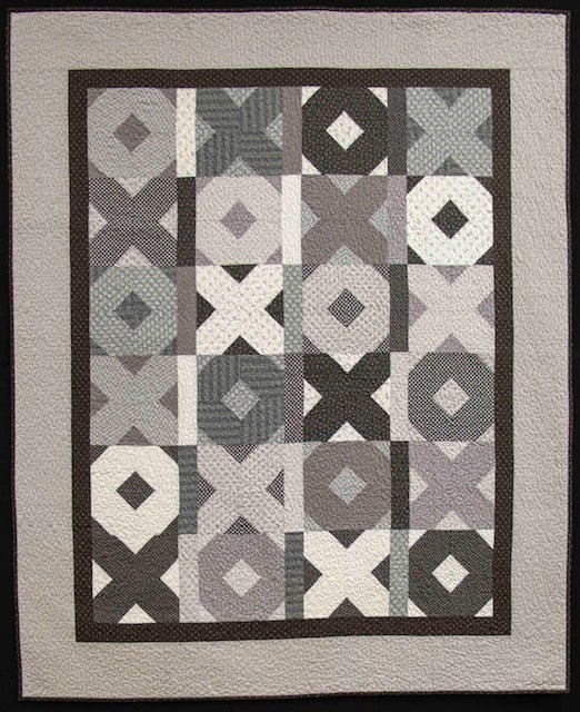 Fun Friends & Fat Quarters Scrappy Hugs and kisses quilt | Fun Friends & Fat Quarters by popular quilting blog, A Quilting Life: image of a black and grey Scrappy Hugs and Kisses quilt.