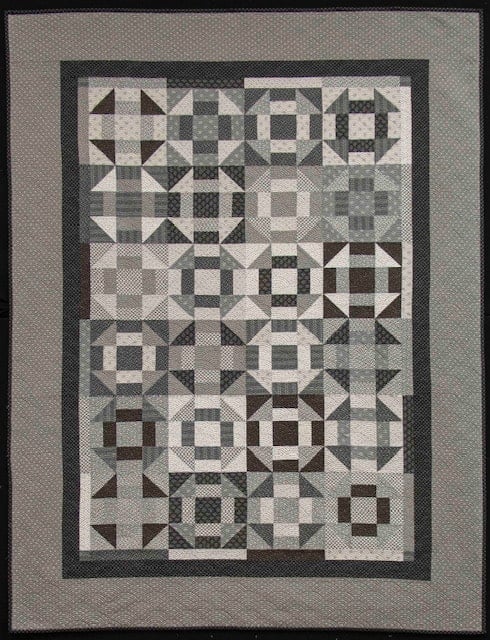Fun Friends & Fat Quarters Scrappy Churn Dash quilt | Fun Friends & Fat Quarters by popular quilting blog, A Quilting Life: image of a black and grey scrappy churn dash quilt.