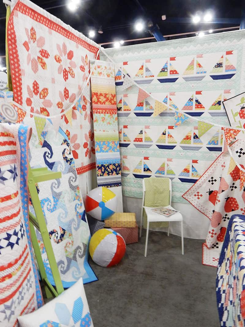 Fig Tree Booth | Moda Booths Part 2: International Quilt Market Fall 2019 by popular Utah quilting blog, A Quilting Life: image of the Catalina collection booth by Fig Tree.
