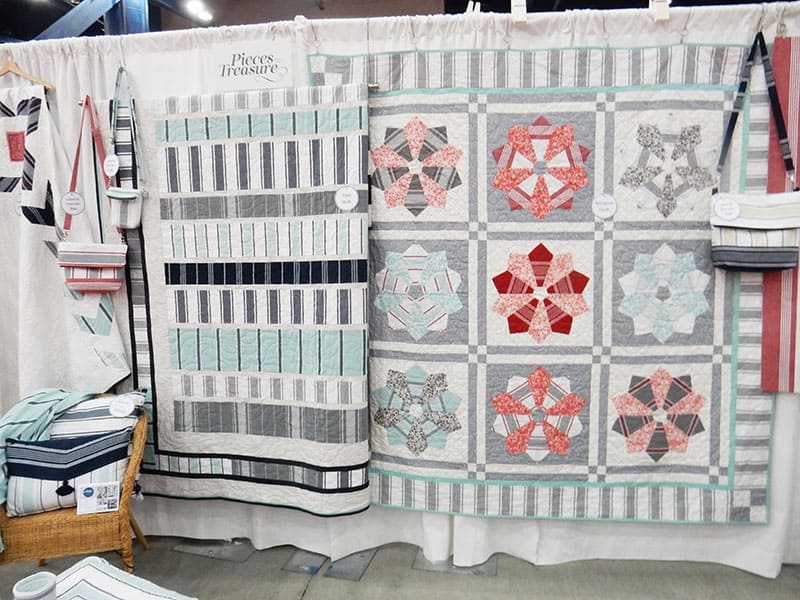 Pieces to Treasure Booth  | Moda Booths Part 2: International Quilt Market Fall 2019 by popular Utah quilting blog, A Quilting Life: image of the Pieces to Treasure booth. 