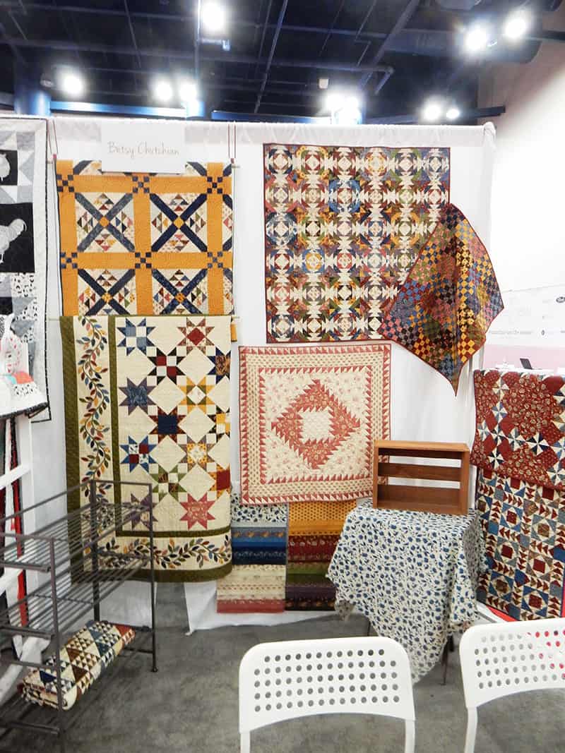 Betsy Chutchian booth | Moda Booths Part 2: International Quilt Market Fall 2019 by popular Utah quilting blog, A Quilting Life: image of the Betsy Chutchian Nancy's Needle Moda booth.