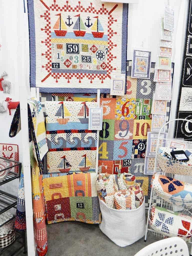 Sandy Klop booth fall 2019 international quilt market | Moda Booths: Fall 2019 International Quilt Market by popular Utah quilting blog, A Quilting Life: image of the Sandy Klop booth. 
