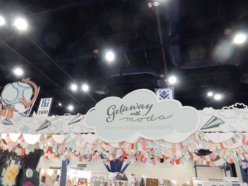 Moda Booths: Fall 2019 International Quilt Market by popular Utah quilting blog, A Quilting Life: image of a Moda sign. 