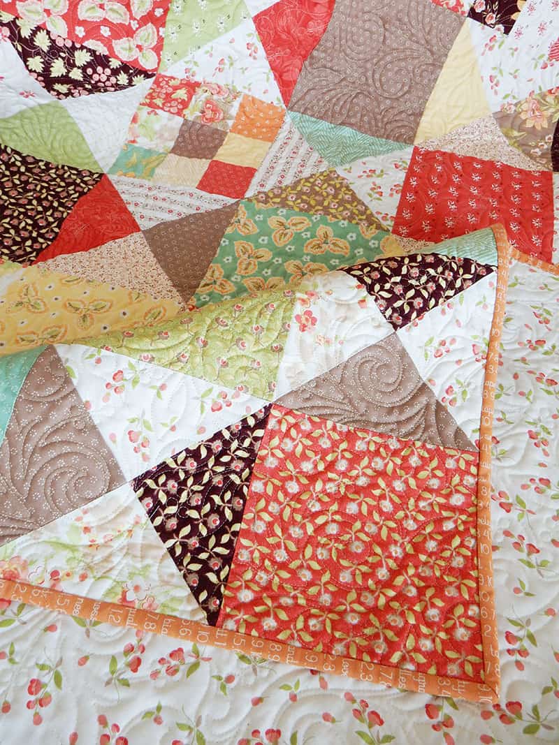 How to Make a Scrap Quilt by popular Utah quilting blog, A Quilting Life: image of a Scrappy Fall quilt by A Quilting Life