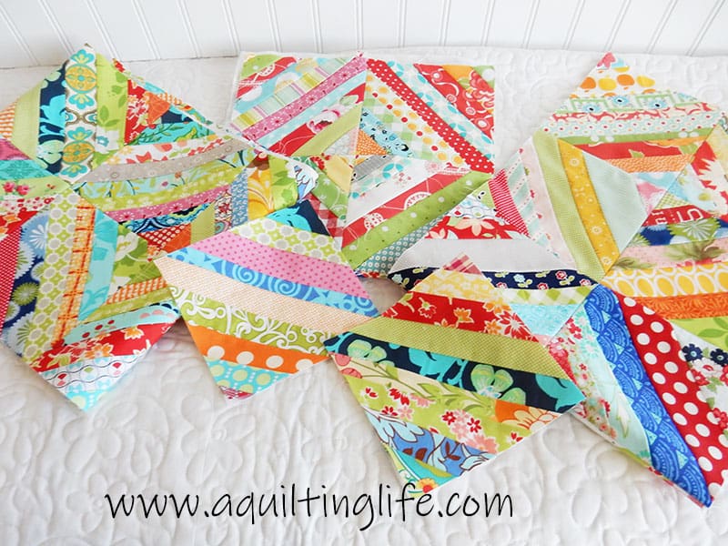 How to Make a Scrap Quilt by popular Utah quilting blog, A Quilting Life: image of a scrappy string quilt blocks