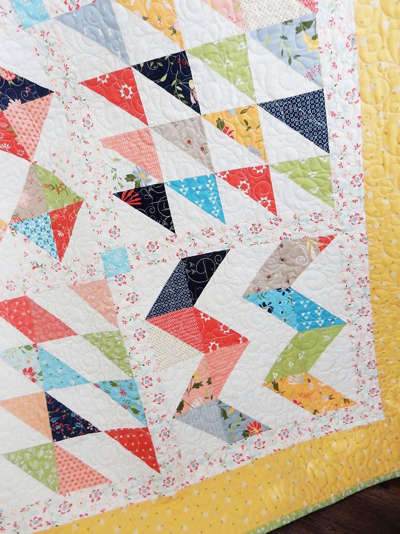Scrappy hst block of the month quilt | 2019 Block of the Month Finishing by popular Utah quilting blog, A Quilting Life: image of a Scrappy HST block of the month quilt.