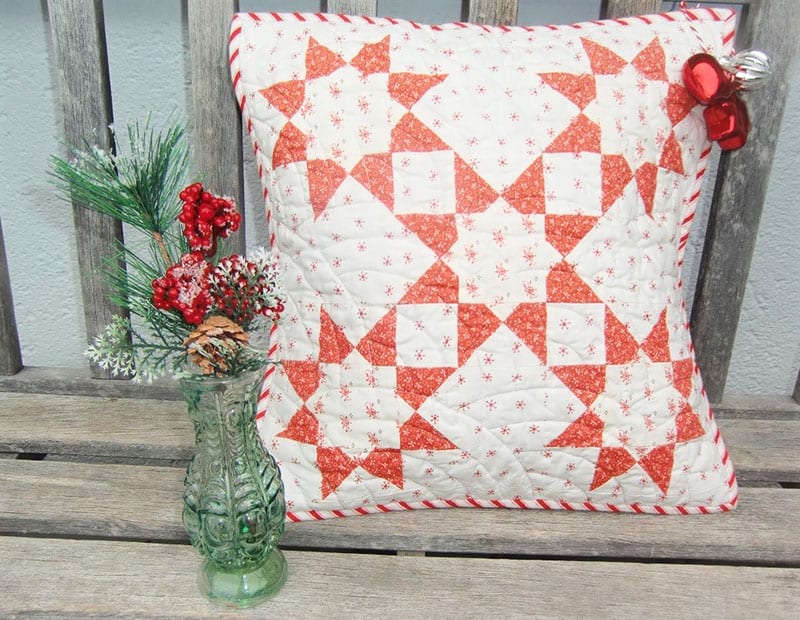 Christmas Star pillow | Star Drop pillow | Minis & More | Small Quilting Project Ideas by popular Utah quilting blog, A Quilting Life: image of a Christmas Star pillow. 