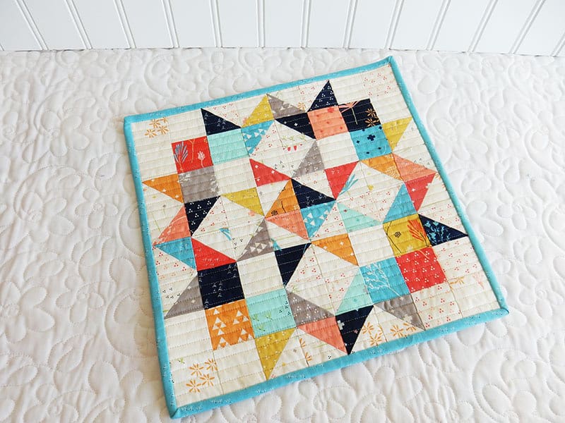 How to Hang Small Quilts featured by Top US Quilting Blog, A Quilting Life: image of Moda Love Mini quilt in Desert Bloom fabrics