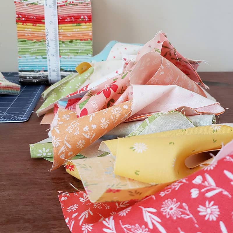 10 Tips for Block of the Month Quilts featured by Top US Quilting Blog, A Quilting Life: image of fabric scraps