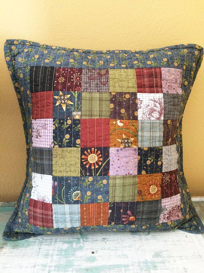 Scrappy Patchwork Pillow | Star Drop pillow | Minis & More | Small Quilting Project Ideas by popular Utah quilting blog, A Quilting Life: image of a Scrappy Patchwork pillow. 