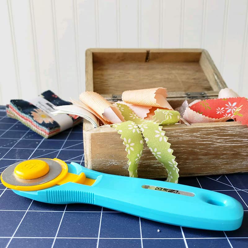 Saturday Seven 115 featured by Top US Quilting Blog, A Quilting Life: image of rotary cutter and fabric scraps