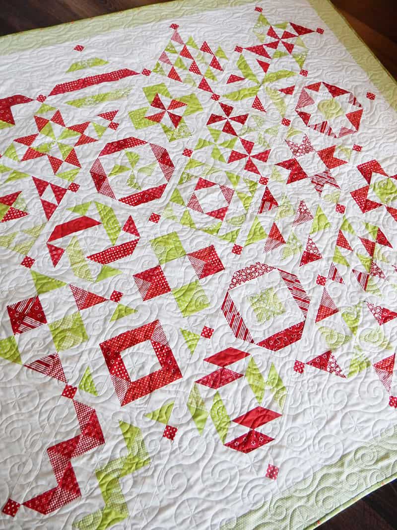 red and green half-square triangle quilt | 2019 Block of the Month Finishing by popular Utah quilting blog, A Quilting Life: image of a red and green half square triangle quilt.