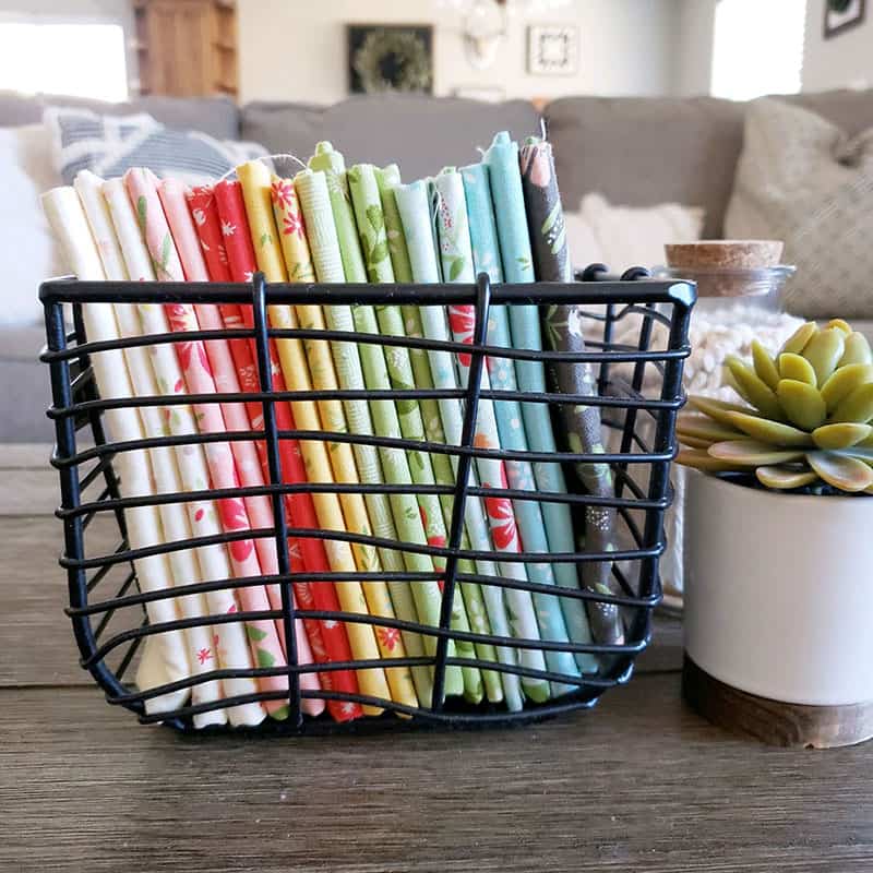 Scraps-Along: 12 Months of Scrappy Challenges featured by Top US Quilting Blog, A Quilting Life: image of fabrics in a basket