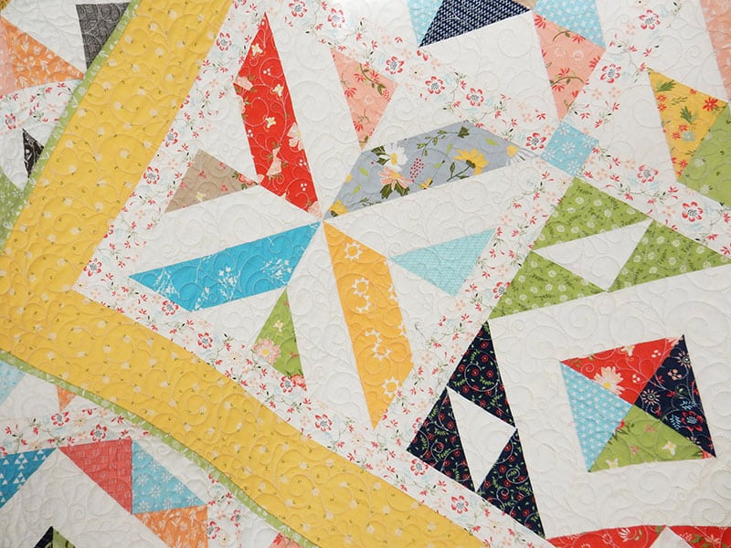 7 Best Tips for Scrap Quilts Featured by Top US Quilting Blog, A Quilting Life: image of half-square triangle scrap quilt