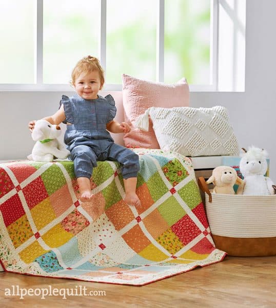 Charm Square Baby Quilt in Quilts & More featured by Top US Quilting Blog, A Quilting Life: image of charm square baby quilt