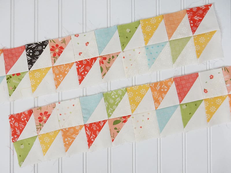 10 Quilt Piecing Tips & Tricks to Improve Piecing Accuracy featured by Top US Quilting Blog, A Quilting Life: image of scrappy half-square triangles