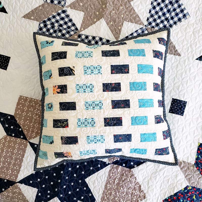 Saturday Seven 118 featured by Top US Quilting Blog, A Quilting Life: image of scrappy pillow in blues