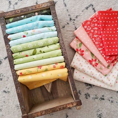Saturday Seven 180 featured by Top US Quilting Blog, A Quilting Life: image of Summer Sweet fabrics in a box