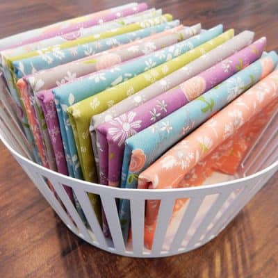 Saturday Seven 126 featured by Top US Quilt Blog, A Quilting Life: image of fabrics in basket
