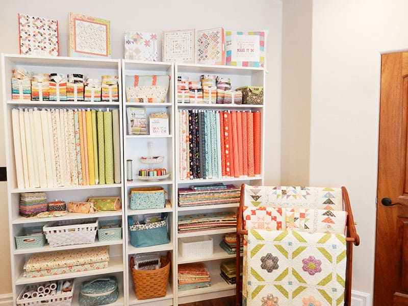 Sewing Room Tour featured by Top US Quilting Blog, A Quilting Life: image of sewing fabric shelves