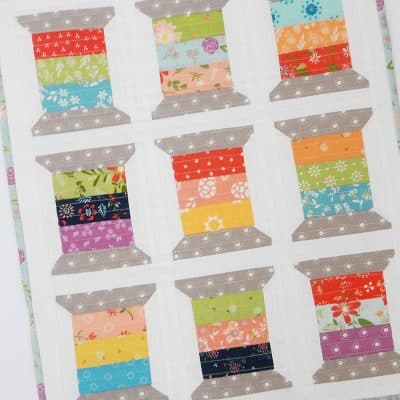 Quick Quilting & Sewing Projects featured by Top US Quilting Blog, A Quilting Life: image of mini spools quilt