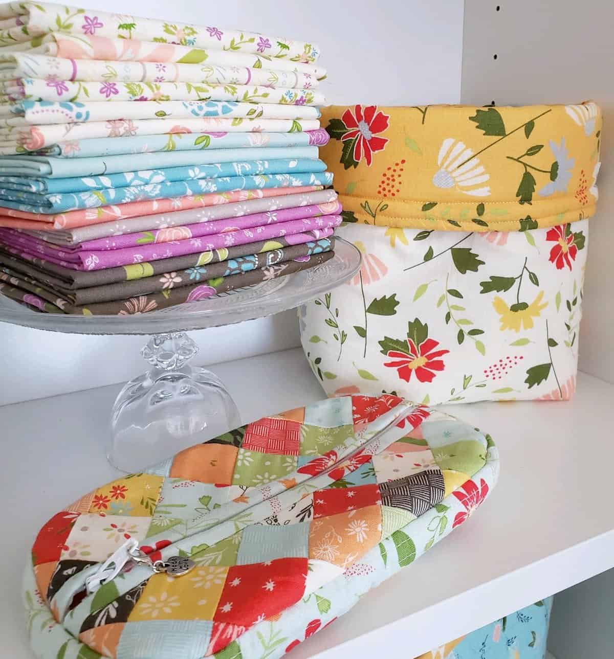 Quick Quilting & Sewing Projects featured by Top US Quilting Blog, A Quilting Life: image of small bag and fabric basket and fabric stack