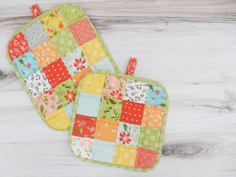 How to Make a Quilted Potholder featured by Top US Quilting Blog, A Quilting Life: Image of quilted potholders