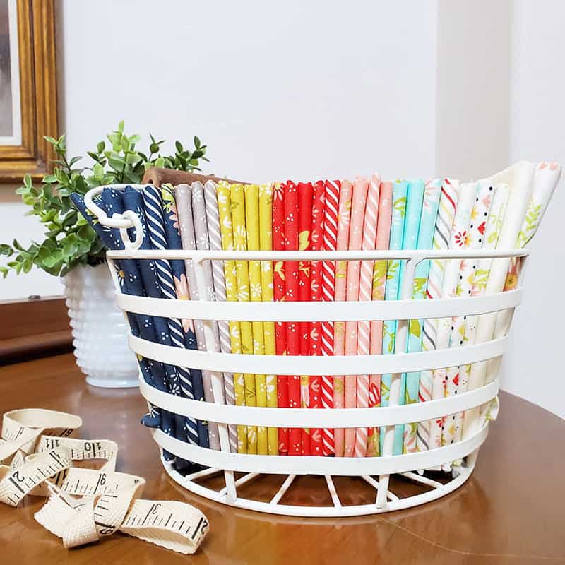 Saturday Seven 143 featured by Top US Quilt Blog, A Quilting Life: image of fabrics in basket
