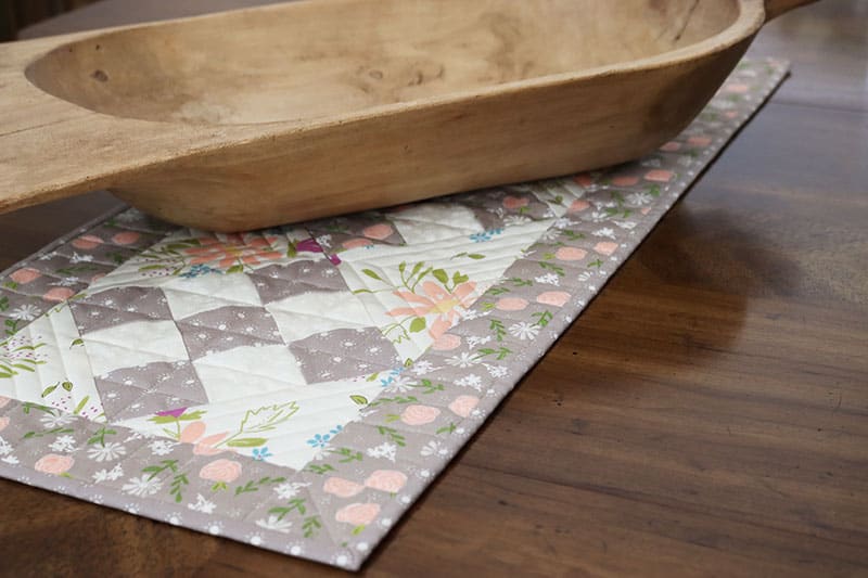 Saturday Seven 164 featured by Top US Quilting Blog, A Quilting Life: image of scrappy 9-patch table runner