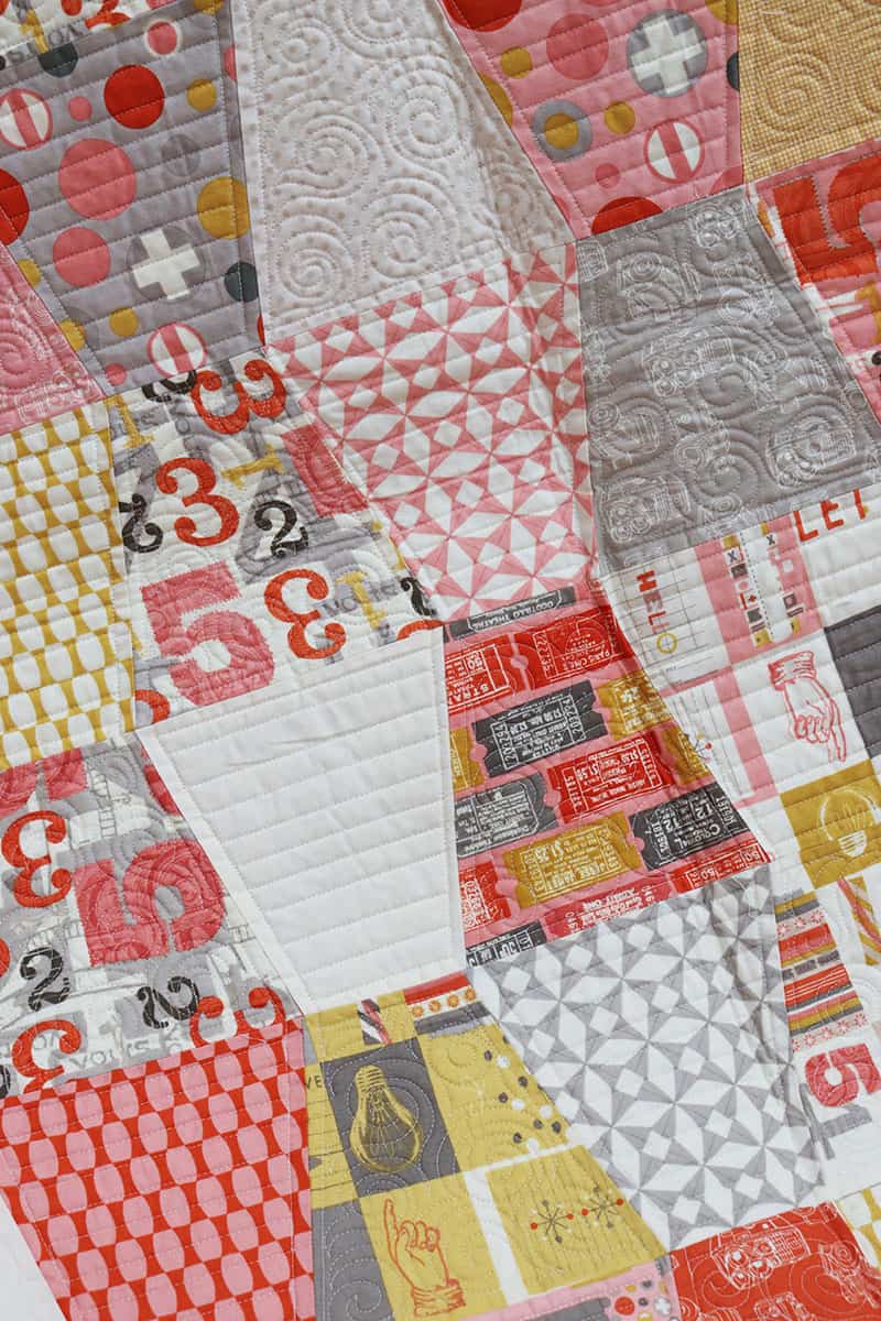 Tumbler Quilt Block Quilts & Projects featured by Top US Quilting Blog, A Quilting Life: image of tumbler shaped patchwork quilt.