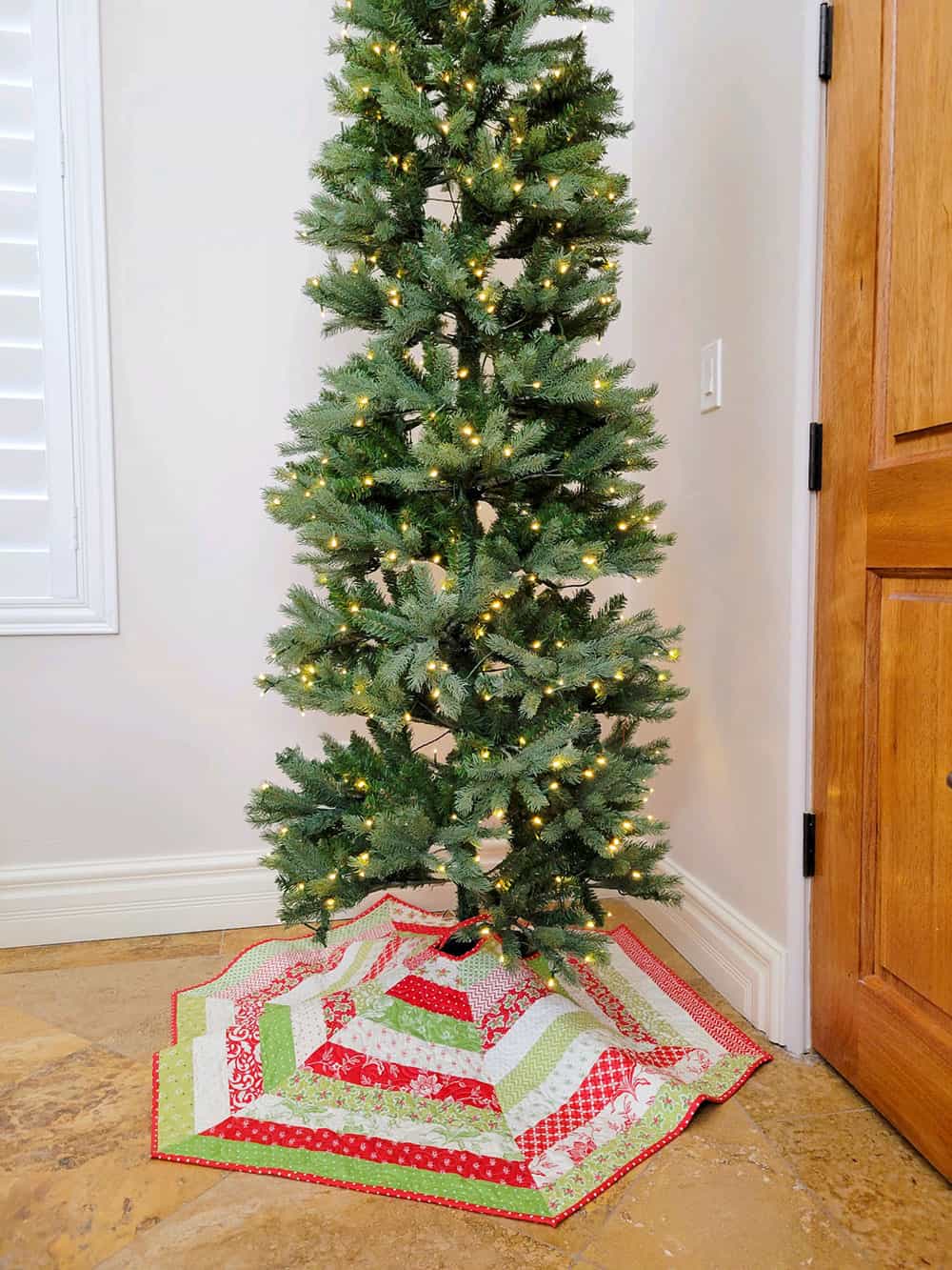 Christmas Tree with patchwork tree skirt pieced by Sherri McConnell from A Quilting Life