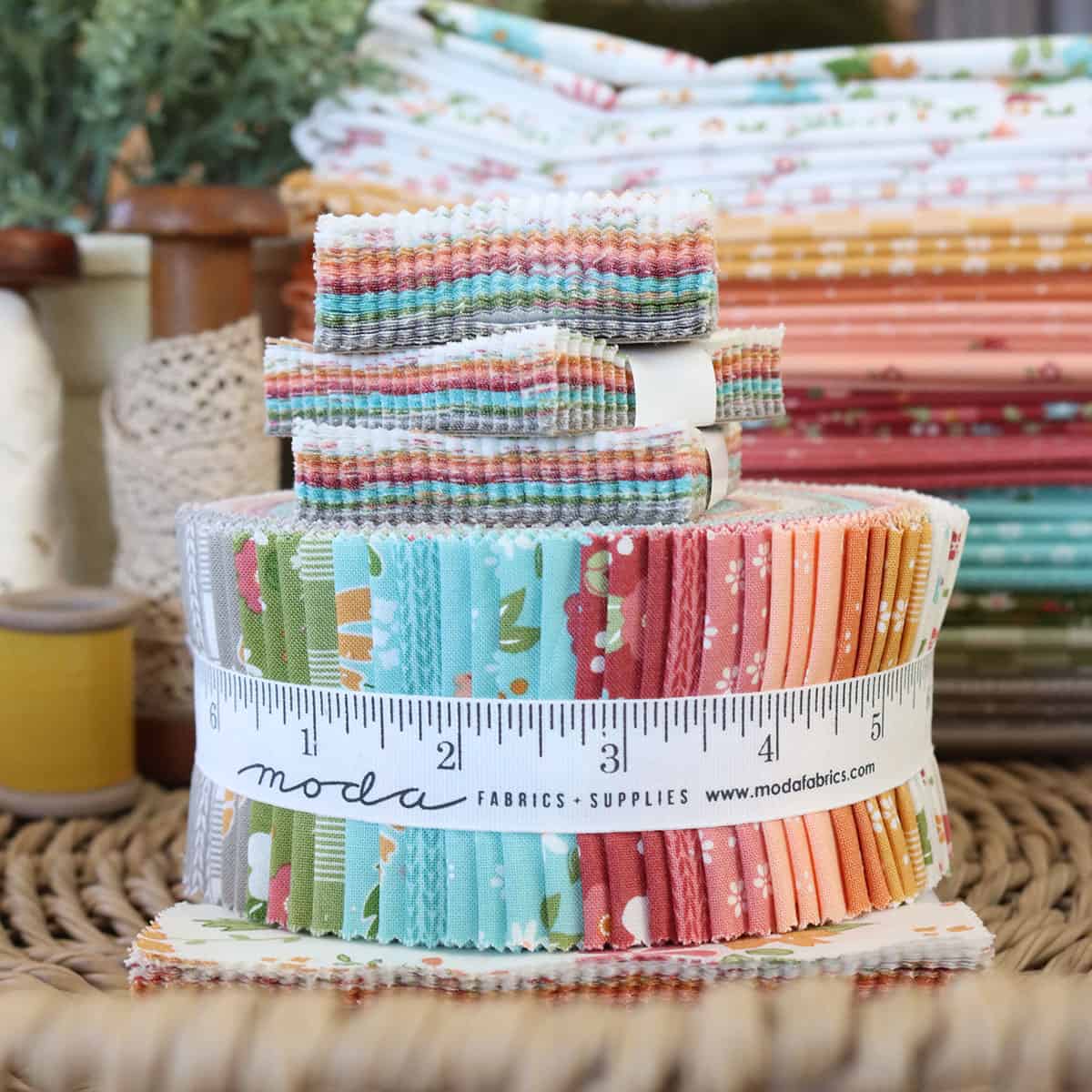 Bright Fall quilting fabrics in grey, green, blue, burgundy, coral, dark orange, and gold