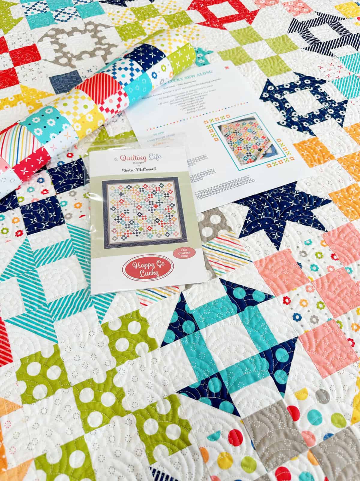 Scrappy patchwork Happy Go Lucky Quilt by Sherri from A Quilting Life