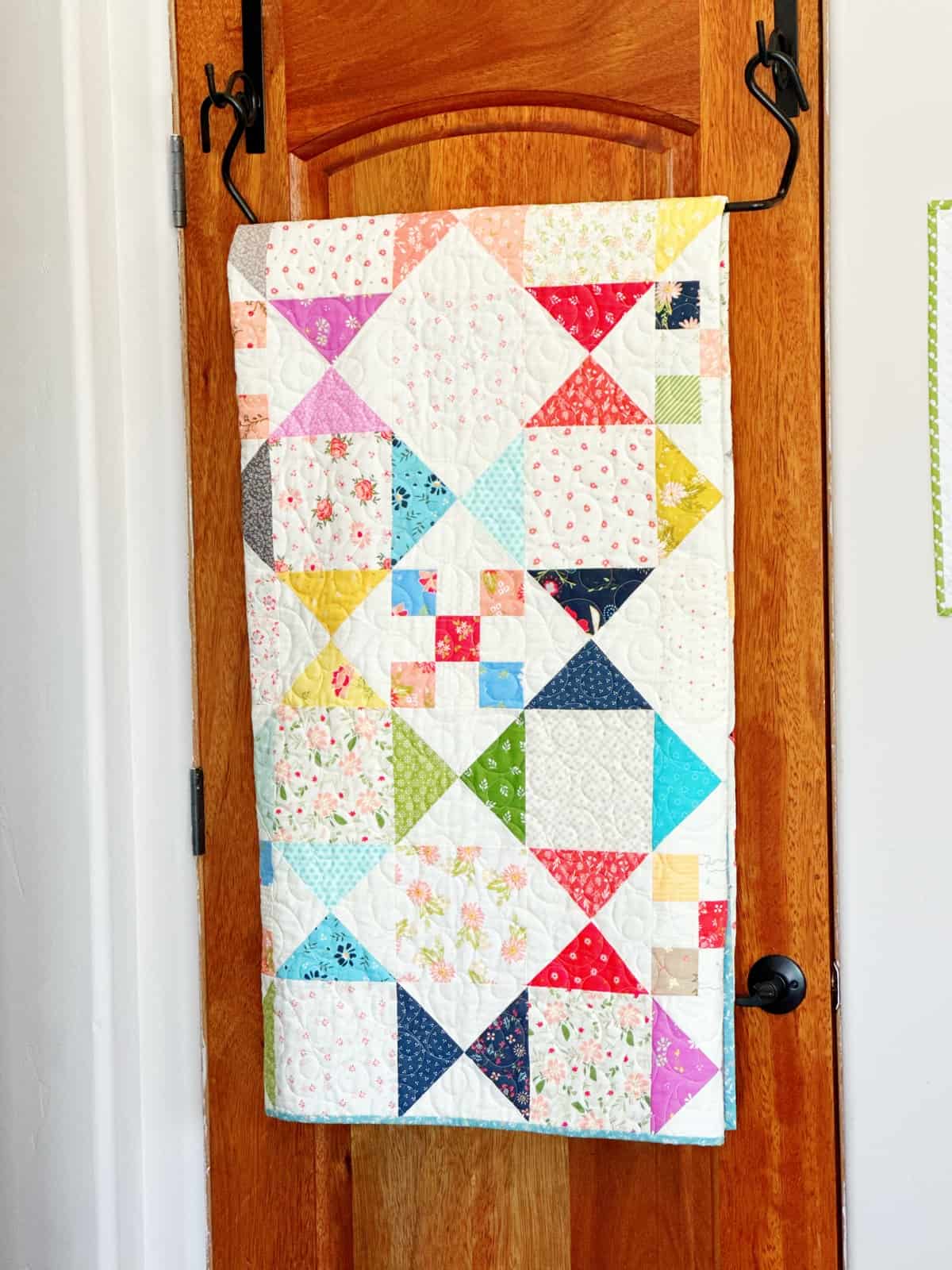 over the door quilt rack with scrappy quilt