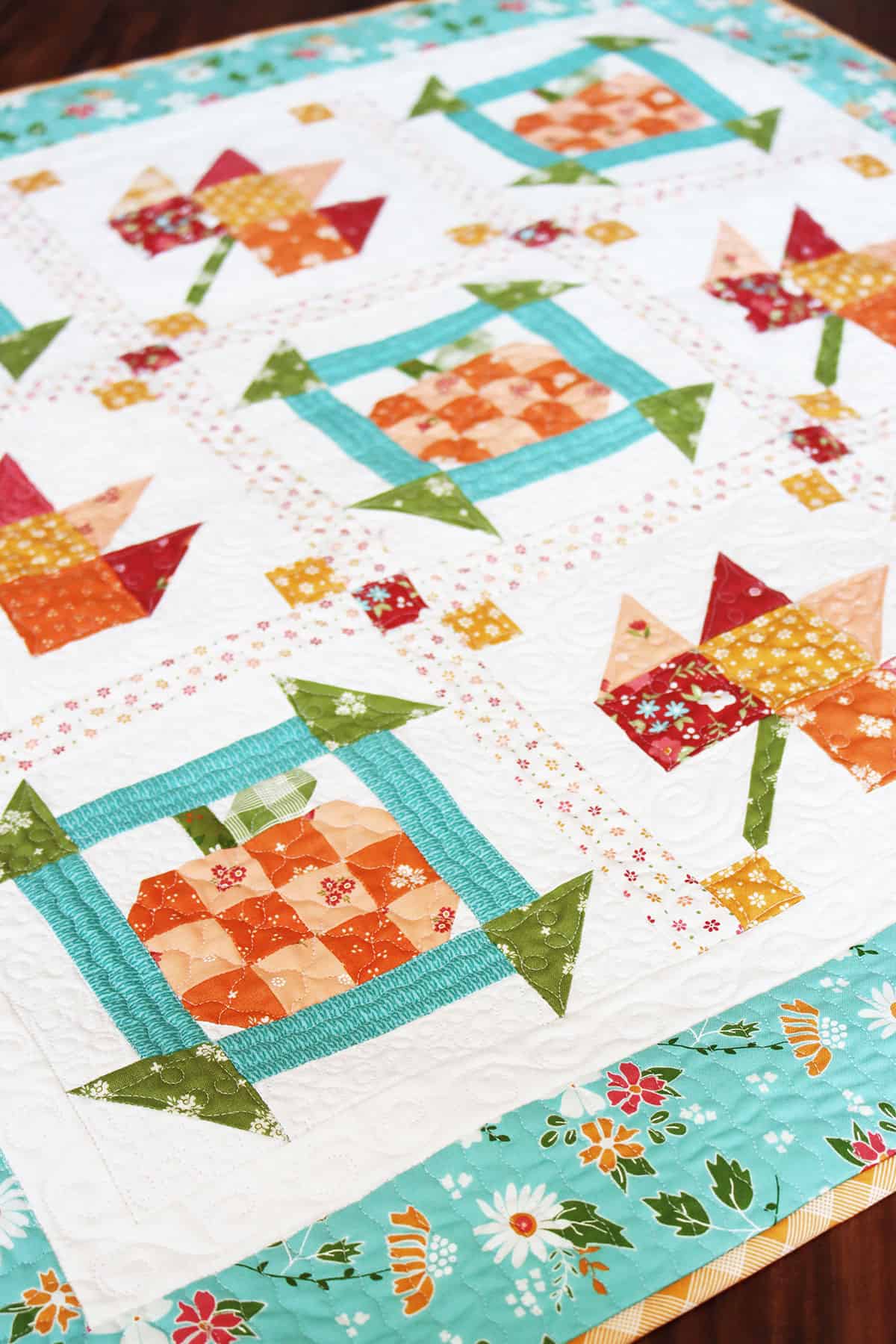 Pumpkin and leaf quilt in beautiful fall fabrics